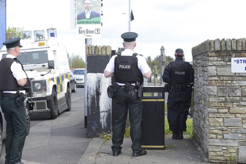 PSNI watch on at the Funeral , As A guard of honour flanks the coffin of Michael Barr at his funeral in Strabane Co Tyrone this morning. Barr was shot dead at the end of April in a pub in Dublin. It is thought his murder is part of a bitter feud between rival gangs in the city.
PACEMAKER BELFAST   05/05/2016